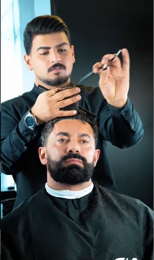 Barber cutting a client's hair at Black Barber Lounge, Beirut